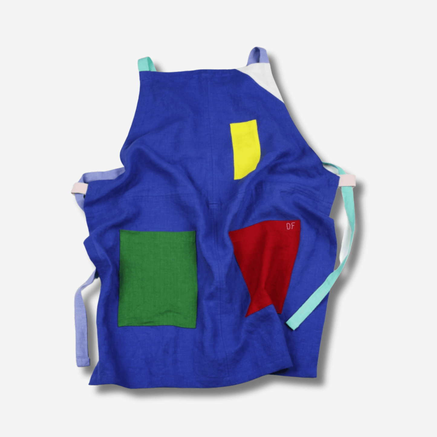 Colorful blue linen apron with contrasting pockets and straps, designed for comfort in kitchen or studio.