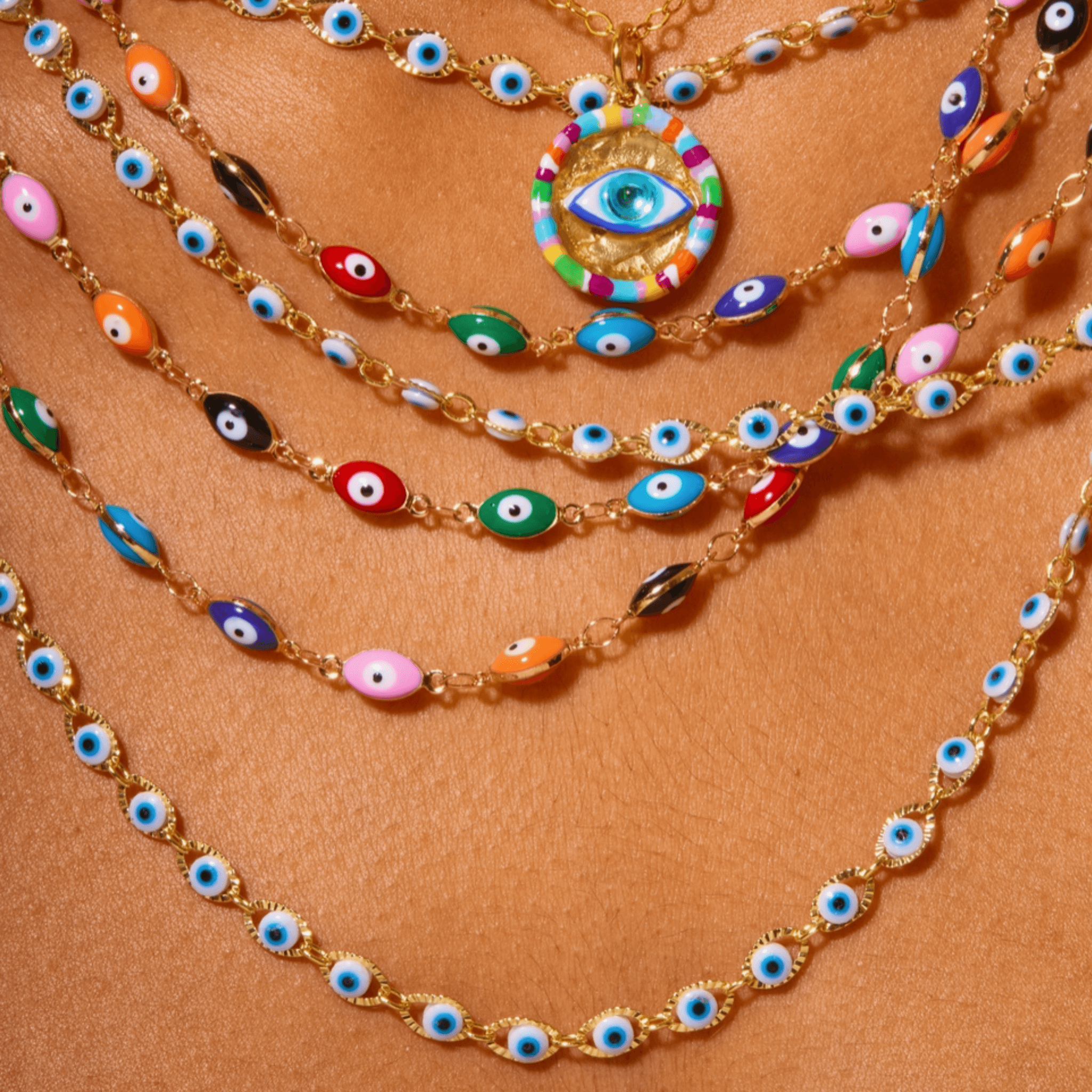 Vibrant Malak Necklace featuring colorful enamel evil eye charms in gold-plated aluminum, perfect for protection and style.