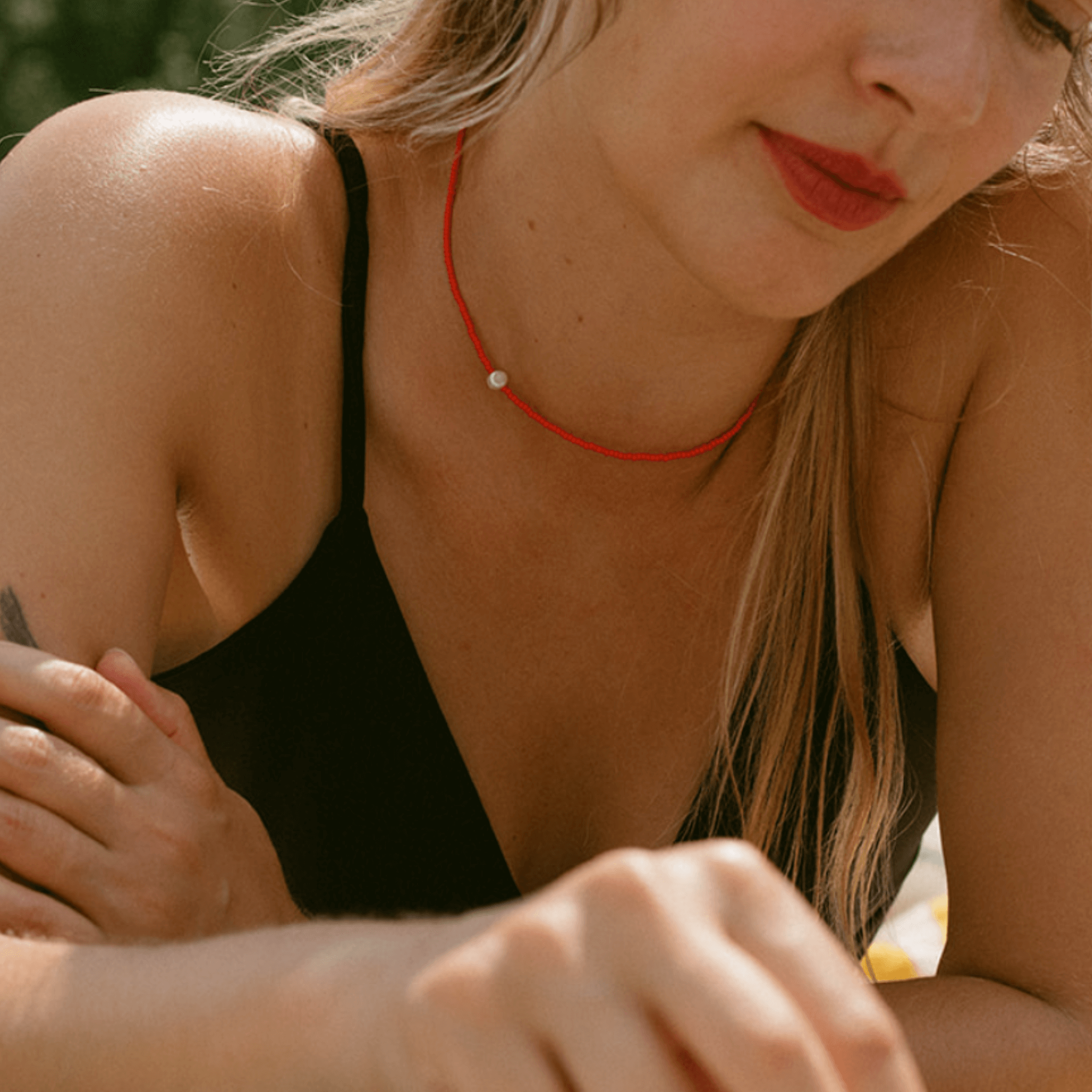 Women wearing a handmade Khadi necklace with a freshwater pearl and silk, radiating simplicity and elegance.