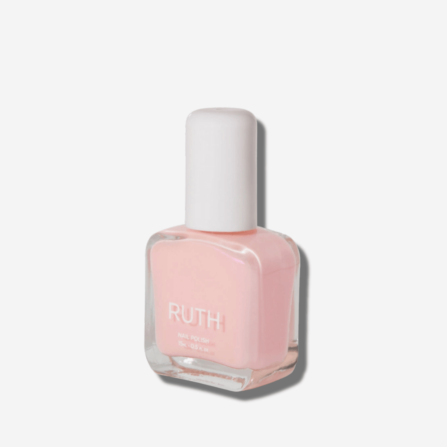 Ruth Angel Nail Polish bottle in sheer baby pink, perfect for a glowing, polished manicure.
