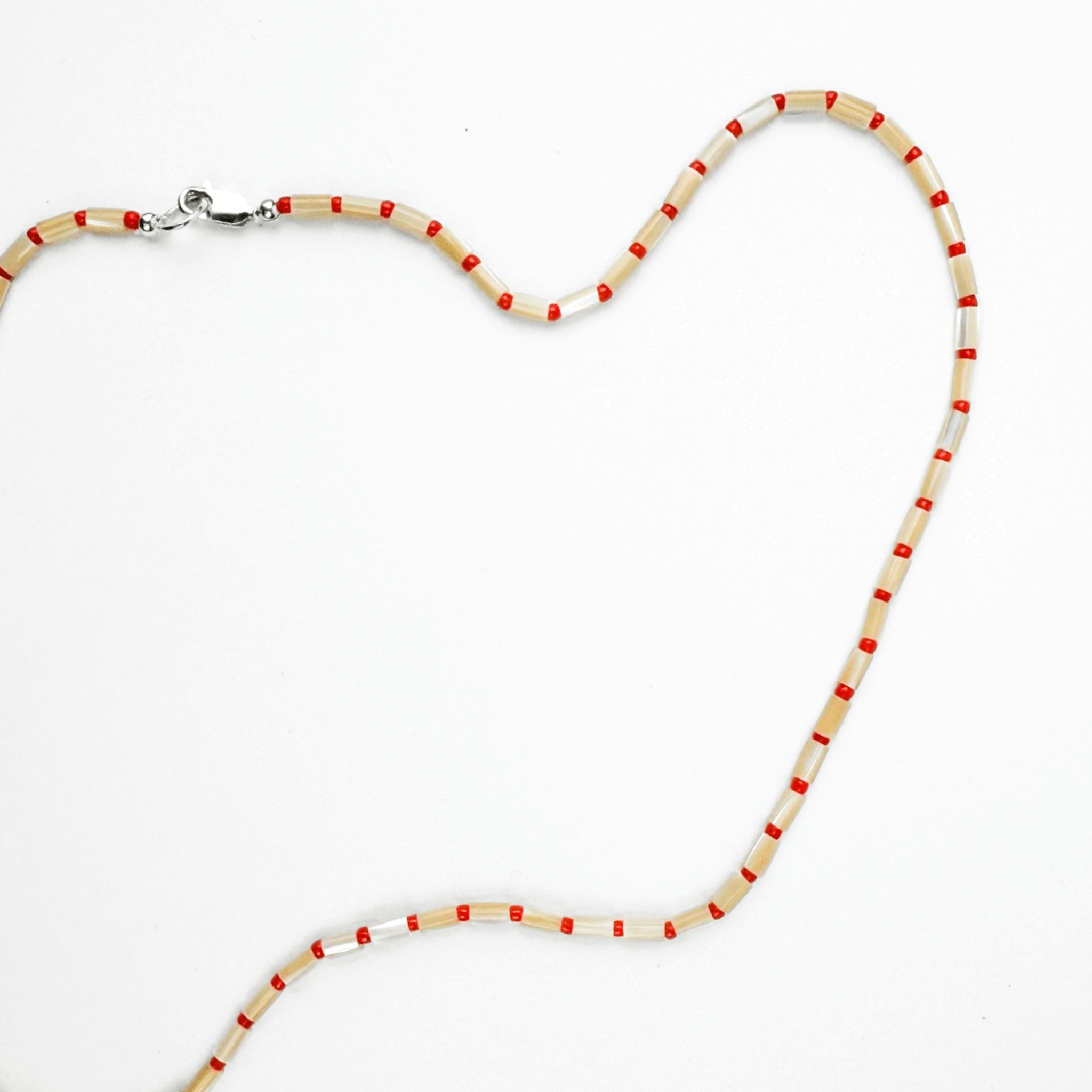 Karo necklace featuring mother of pearl and Japanese glass beads in warm sunset tones, perfect for everyday layering.