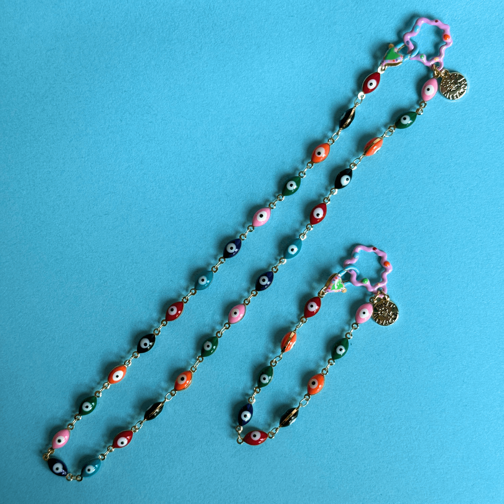 Colorful Malak bracelet with evil eye charms, crafted from gold-plated aluminum and enamel, 6.5" long.