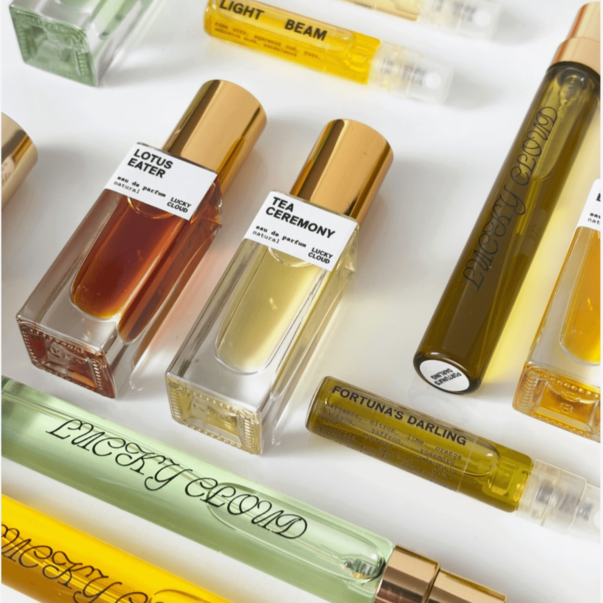Vibrant collection of natural perfumes including Fortuna's Darling and Tea Ceremony, showcasing eco-friendly beauty.