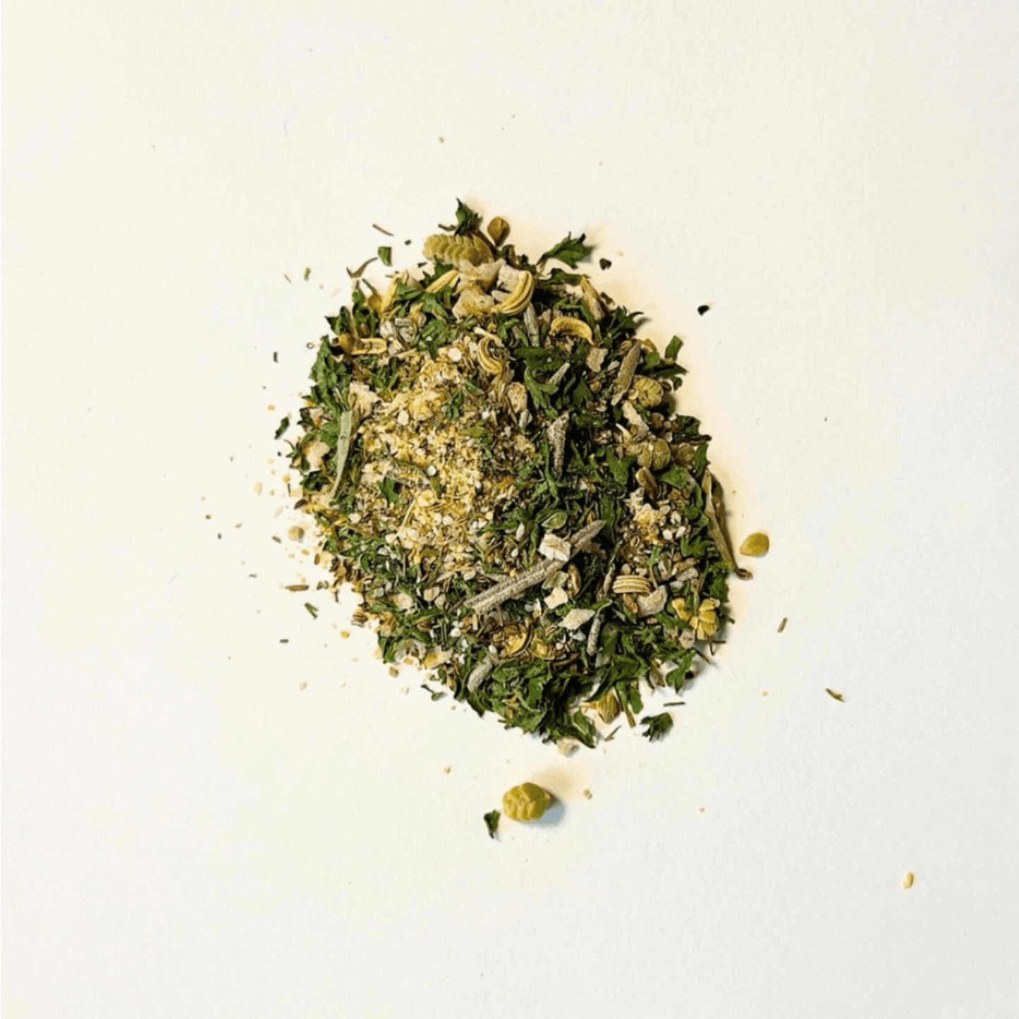 Herby Spice blend showcasing a vibrant mix of herbs, seeds, and citrus on a clean white background.