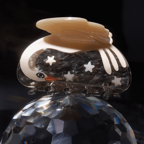 CYGNUS SWAN + STARS HAIR CLAW showcasing celestial elegance with swan design and shimmering stars.
