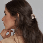 Woman with long hair using a mini agate hair claw clip in an elegant updo hairstyle.