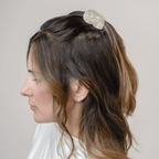 Woman wearing the SIREN MINI HAIR CLAW in a seashell design, adding mermaid energy to her hairstyle.