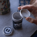 Open container of Day Moon Bod Powder showing the talc-free herbal body care product inside.