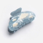 Lightweight Lucy Hair Claw with blue base and white clouds, adding magic to everyday hairstyles.