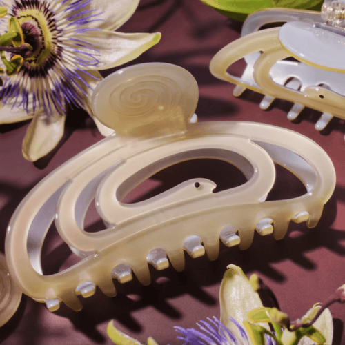 Stylish CORRA HAIR CLAW in pale green, featuring a lightweight cutout design, ideal for medium to long hair.