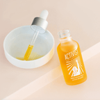 Bottle of Precious Oils Active Infusion facial oil with dropper on a light background, showcasing its rich, golden hue.