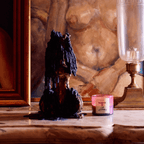 NUEVE LEONES candle with bold scent displayed in artistic setting, surrounded by vintage decor.