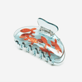 Playful goldfish hair claw in orange and clear, adding charm and shine to your hairstyle.