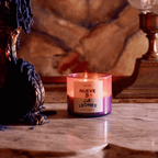 NUEVE LEONES candle glowing on a marble surface, featuring bold colors and a stylish label for a modern ambience.