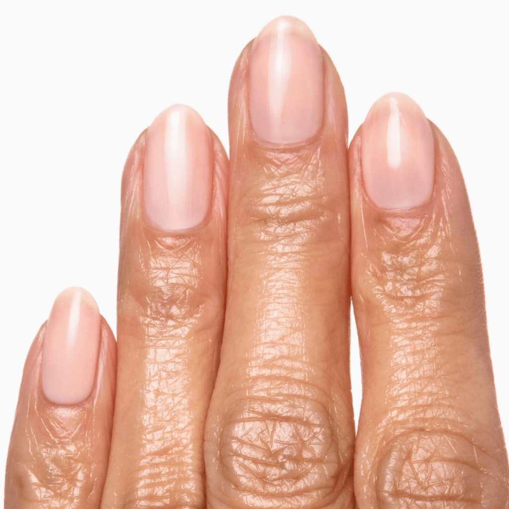 Close-up of manicured nails painted with Forever Wear Chill Paint in Rose Milk, showcasing a soft, pinky nude finish.