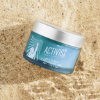 Vivid blue SEA TO SKIN Cleansing Gel in a jar on sandy beach, 50ml, melts makeup and nourishes skin.