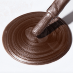 Close-up of Forever Wear Chill Paint in rebellious grey-copper polish swirled on a surface.