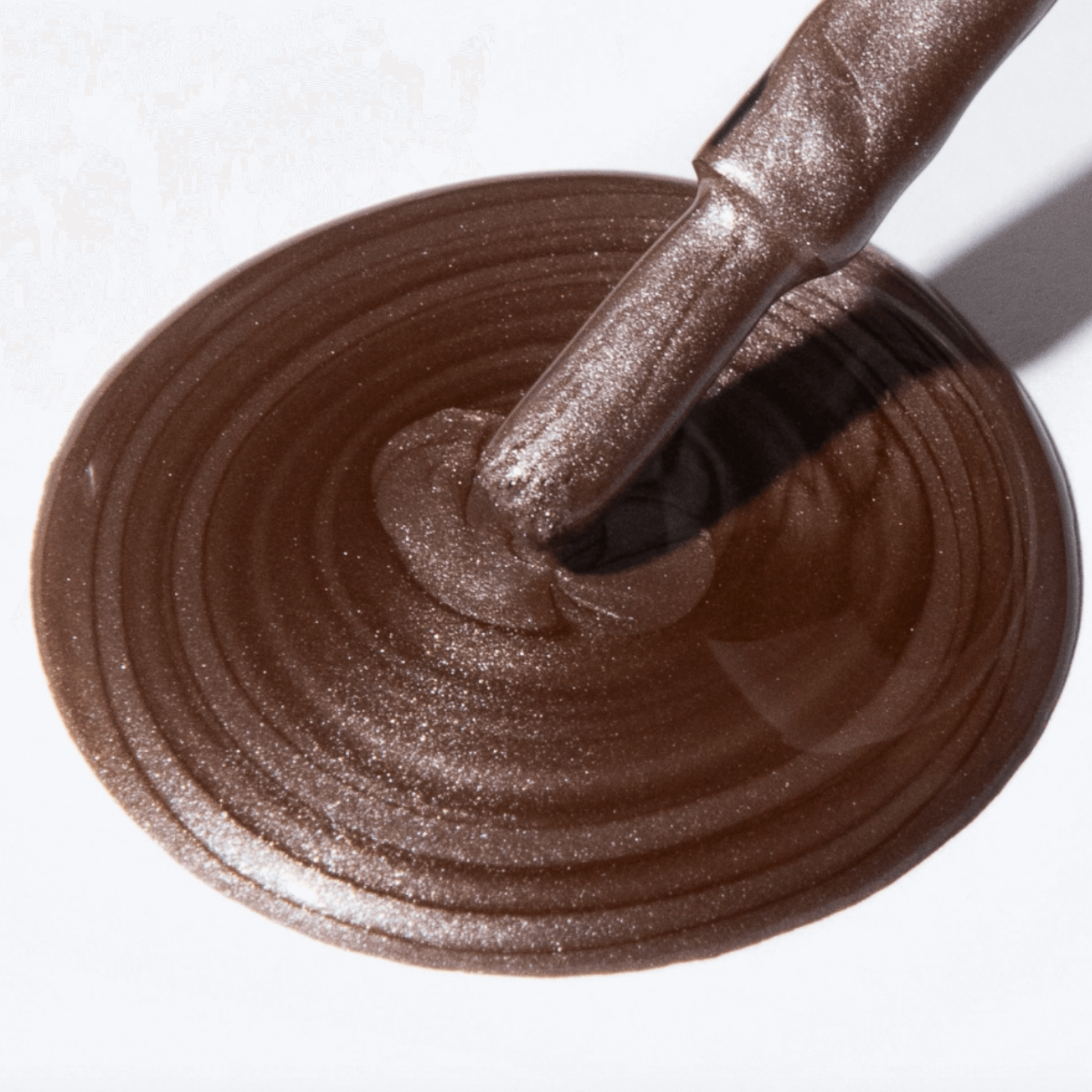 Close-up of Forever Wear Chill Paint in rebellious grey-copper polish swirled on a surface.