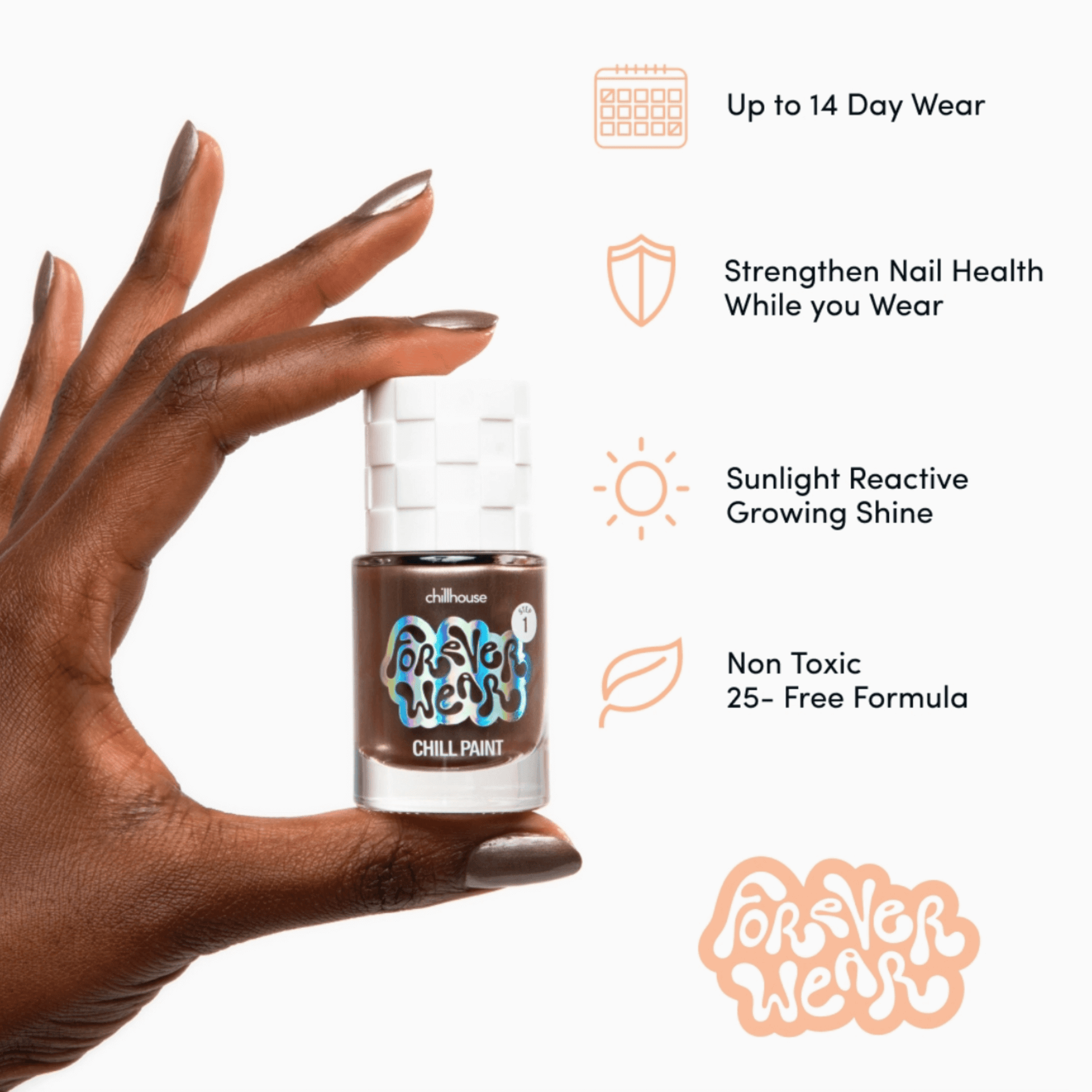 Hand holding Forever Wear Chill Paint nail polish showcasing moody grey-copper shade and benefits.