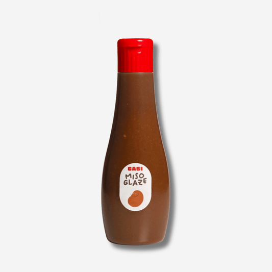Bottle of Cabi Miso Glaze with a bold flavor, perfect for marinades and BBQ, showcasing a rich umami taste.