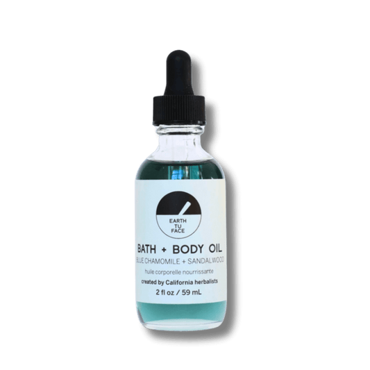 2 oz bottle of Bath and Body Oil with blue chamomile and sandalwood, handcrafted in California for deep hydration.