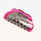 Vibrant pink dragon fruit hair claw clip with leopard print interior, perfect for a playful hairstyle.