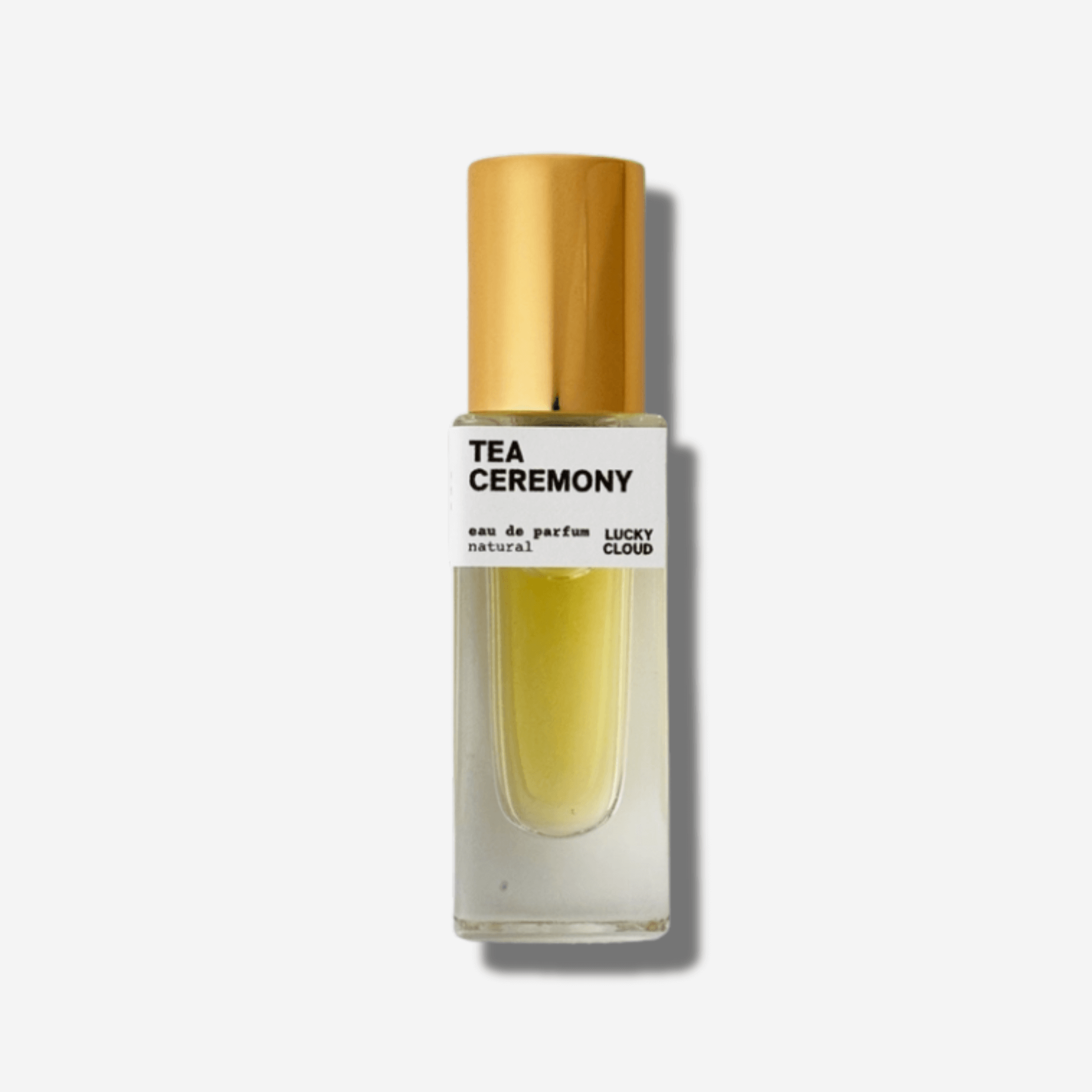 Natural perfume bottle of Tea Ceremony with golden cap, featuring green tea, mango ginger, and ambergris honey scents.
