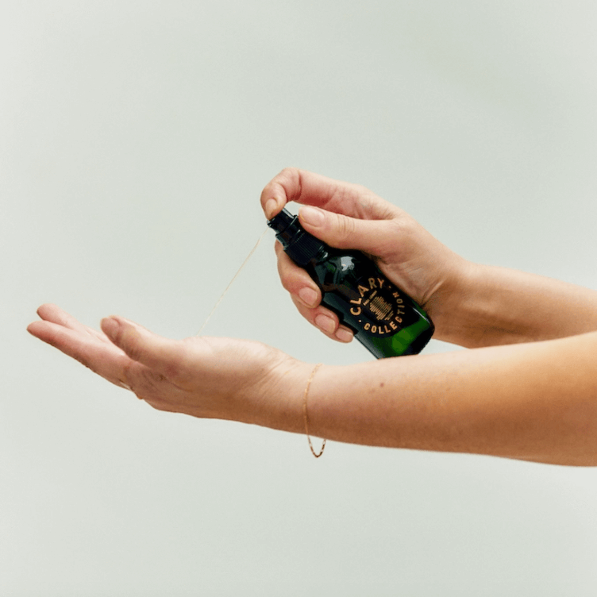 Clary Collection face serum being dispensed onto a hand, showcasing its lightweight, hydrating formula.