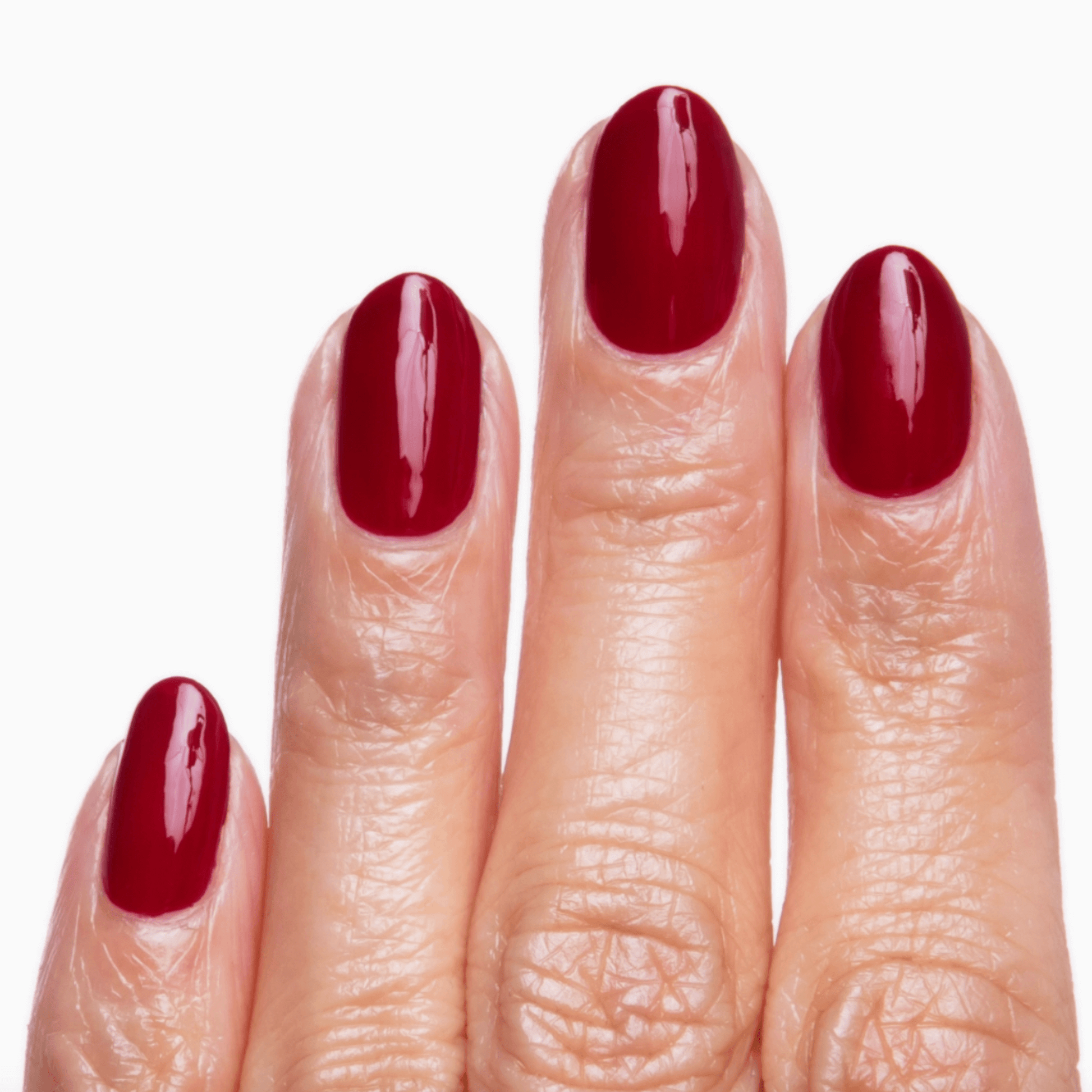 Close-up of manicured nails painted in Natty Wine red using Forever Wear Chill Paint for a glossy finish.