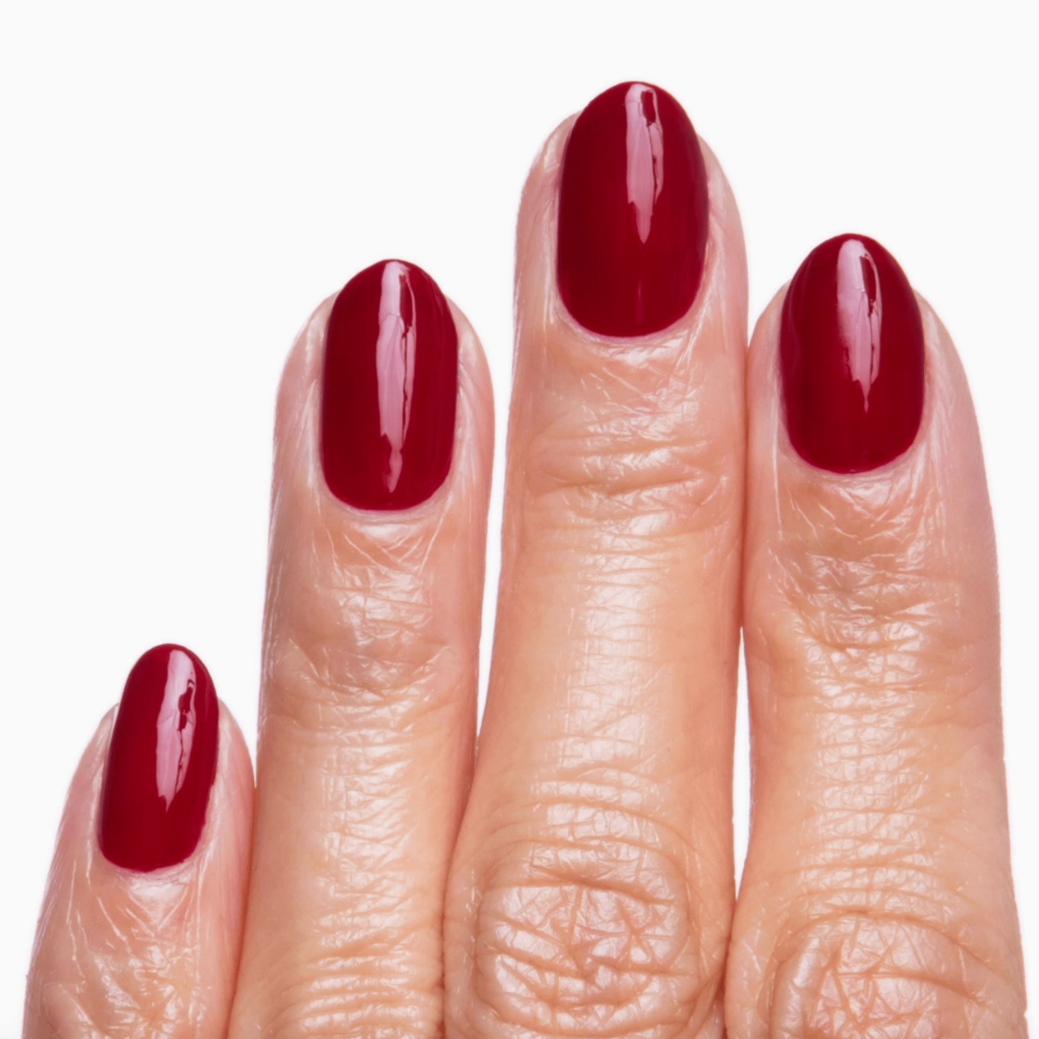 Close-up of manicured nails painted in Natty Wine red using Forever Wear Chill Paint for a glossy finish.