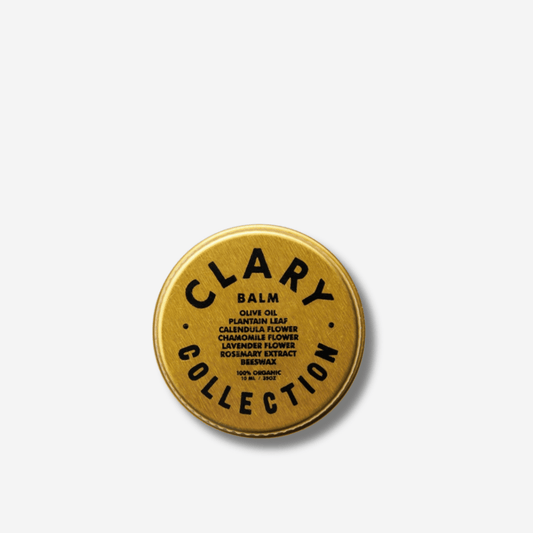 Clary Collection balm tin featuring olive oil, plantain, chamomile, lavender, and rosemary extracts for soothing skin.