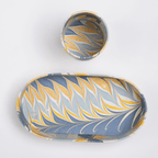 Hand-marbled tray and cup set in golden blue, featuring artistic patterns for stylish organization and display.