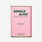 Decorative pink can of Single & Fat organic extra virgin olive oil, showcasing bold branding for premium cooking.
