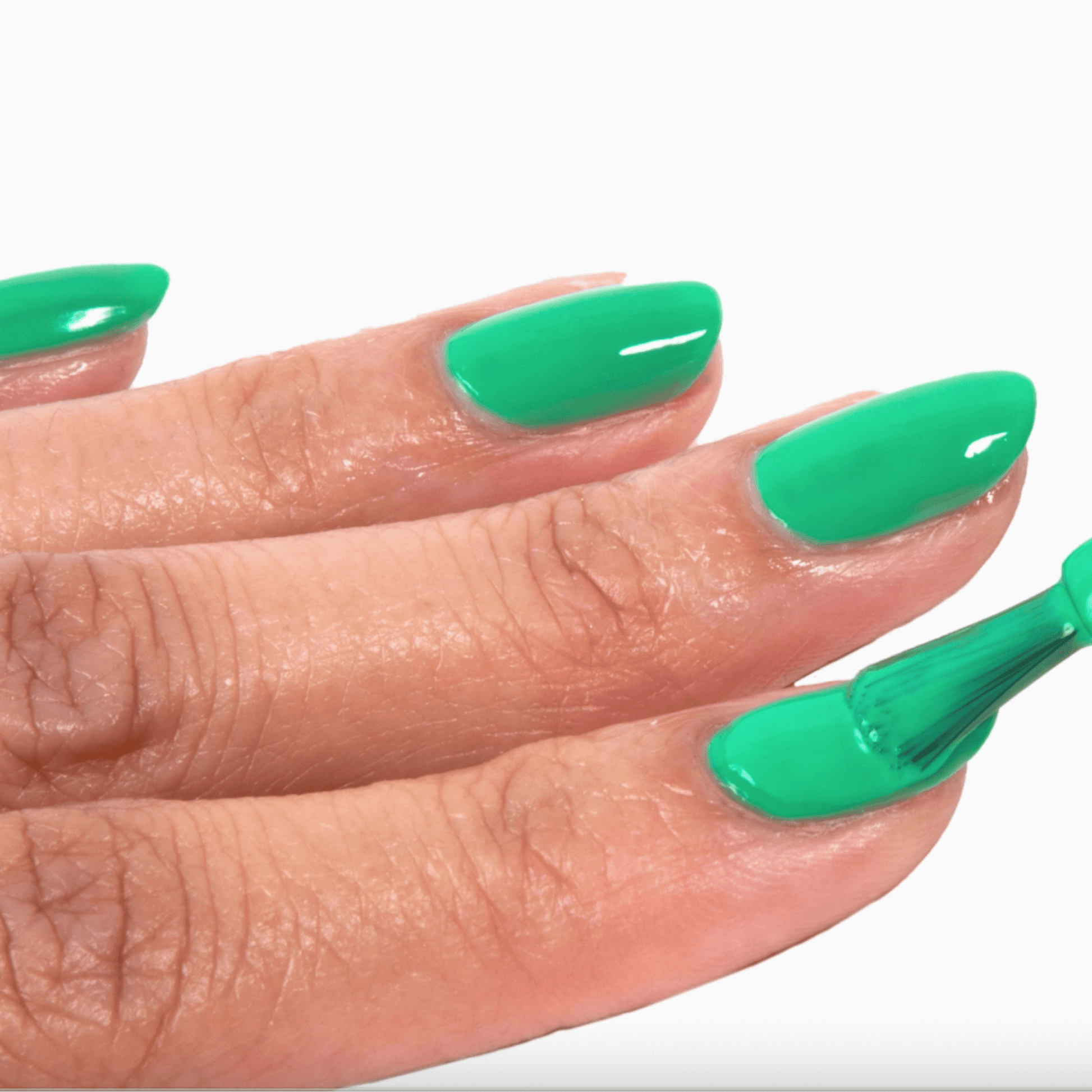 Swatch of Forever Wear Chill Paint in dreamy jade green, applying polish for a vibrant, long-lasting manicure.