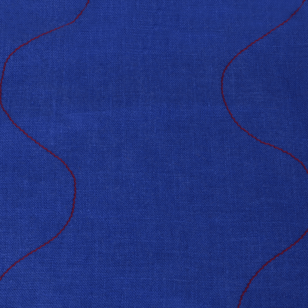 Wavy linen tea towel in vibrant blue with red stitching detail, perfect for kitchen use and decor.