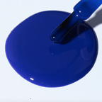 A vibrant electric blue polish spill showcasing Forever Wear Chill Paint - Cobalt Klein for stunning manicures.
