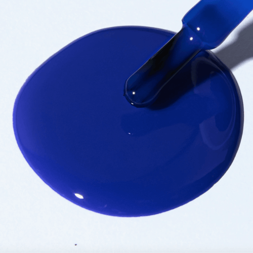 A vibrant electric blue polish spill showcasing Forever Wear Chill Paint - Cobalt Klein for stunning manicures.