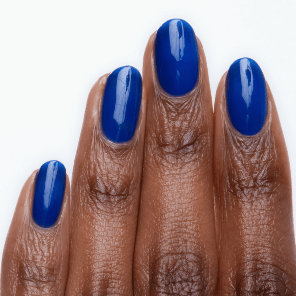 Close-up of manicured nails painted in electric blue Forever Wear Chill Paint, showcasing a glossy finish.