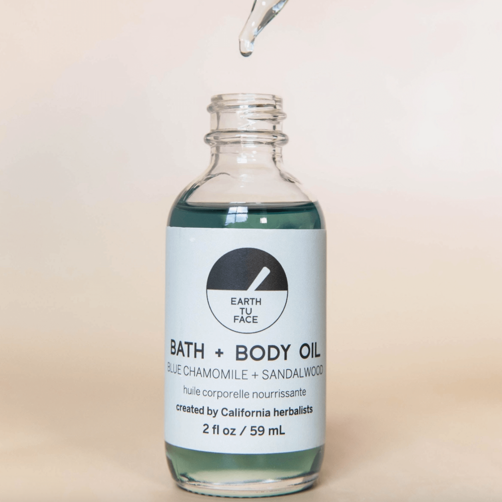 Bath and Body Oil bottle with blue chamomile and sandalwood, crafted by California herbalists, 2 oz for deep hydration.