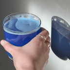 Refreshing blue lemonade drink held in hand, showcasing Magic Magnesium's vibrant color and energizing benefits.