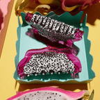 Bright dragon fruit hair claw clips in vibrant pink and speckled design, perfect for playful hair styling.