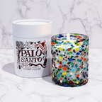 Colorful Palo Santo bubble glass candle next to its stylish white container by Putnam Design.