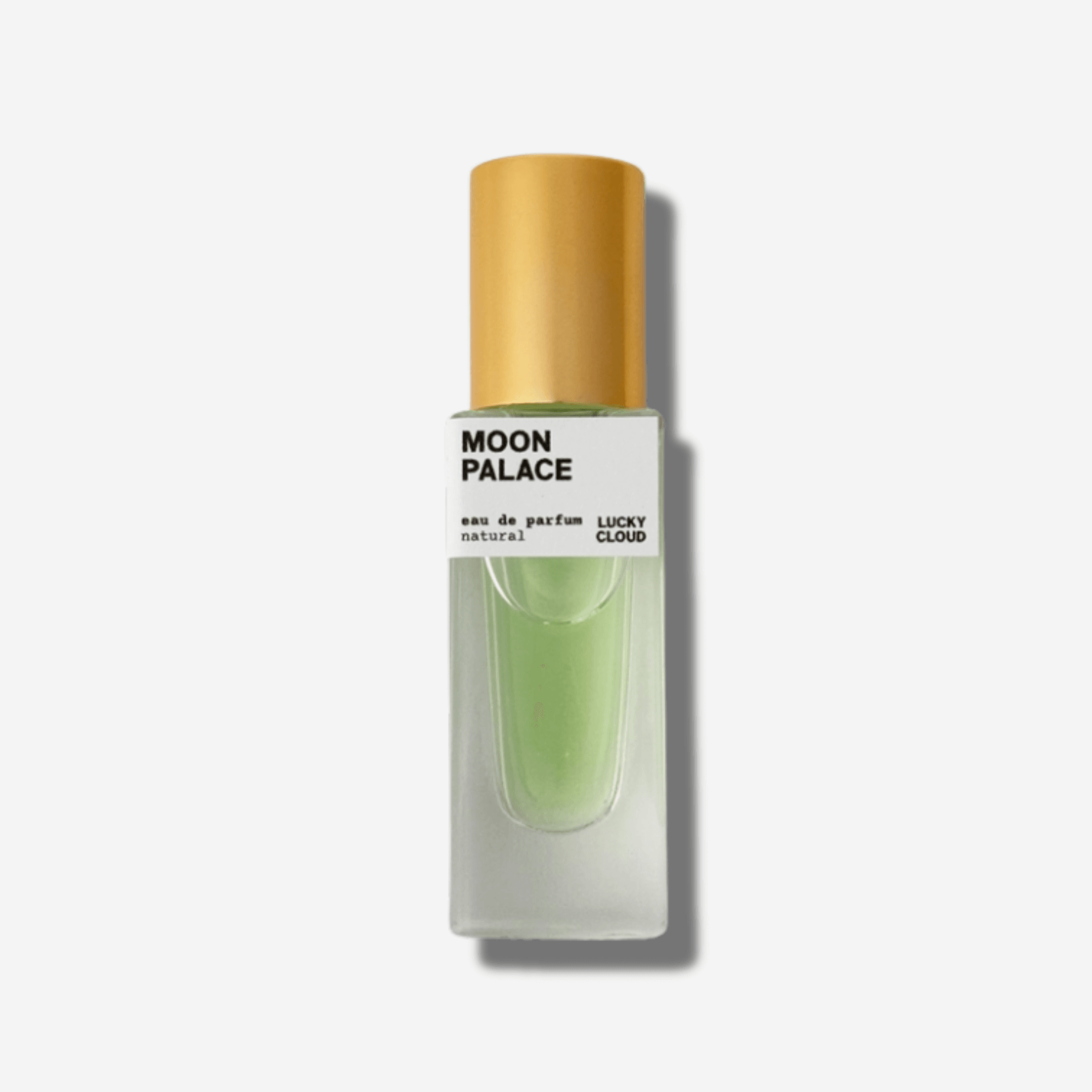 Moon Palace Natural Perfume bottle with gold cap, showcasing earthy green essence and elegant design.