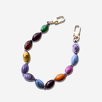 Colorful beaded bag charm with marbled resin beads in vibrant hues and gold clip for easy attachment.