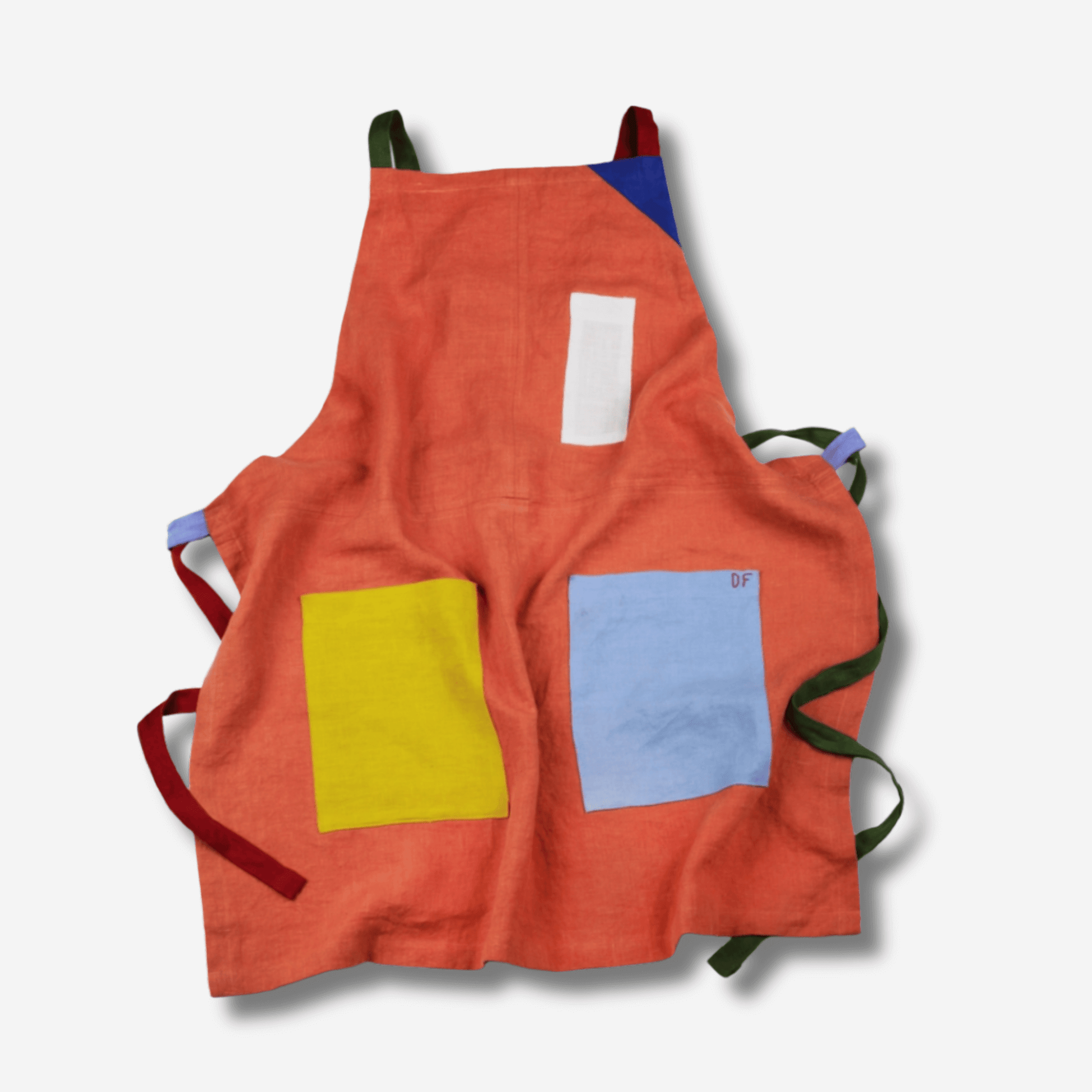 Colorful orange linen apron with contrasting pockets, designed for comfort and creativity.