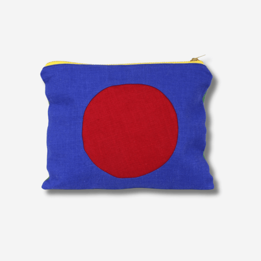 CIRCLE LINEN ZIPPER POUCH in blue and red featuring a bold brass zipper, perfect for makeup or travel essentials.