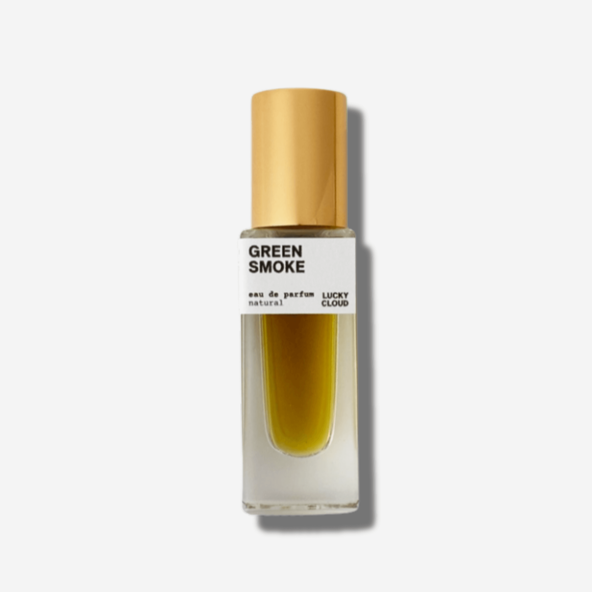 Green Smoke natural perfume bottle with golden cap, showcasing earthy and herbaceous scent profile.