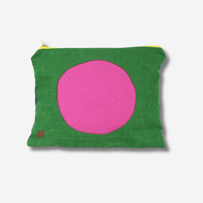 Colorful circle linen zipper pouch featuring a green exterior and playful pink circle design, perfect for storing essentials.