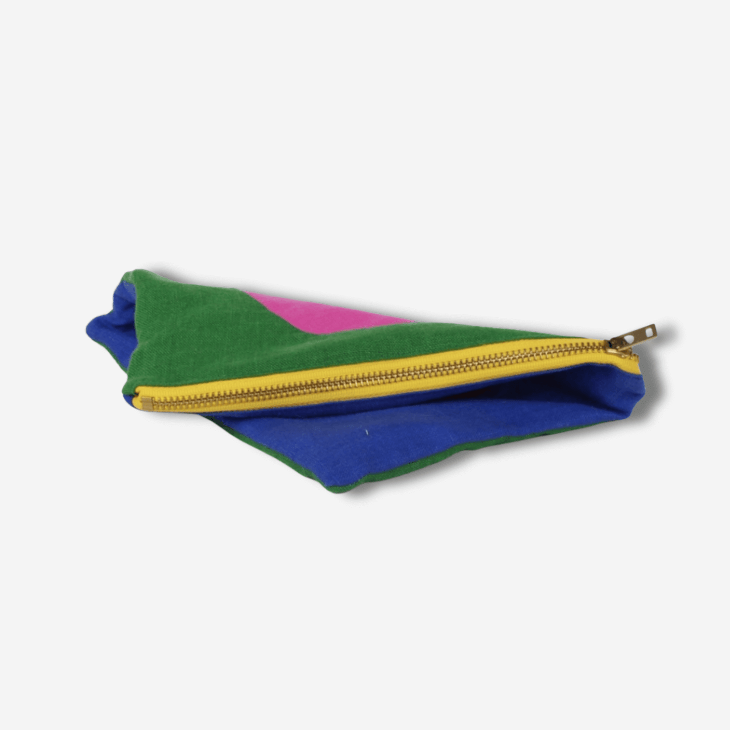 Vibrant CIRCLE LINEN ZIPPER POUCH with bold colors and a yellow brass zipper, perfect for makeup or travel essentials.