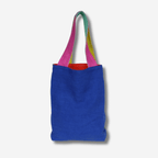 Small linen tote bag in vibrant blue with colorful straps, perfect for errands and minimalist style.